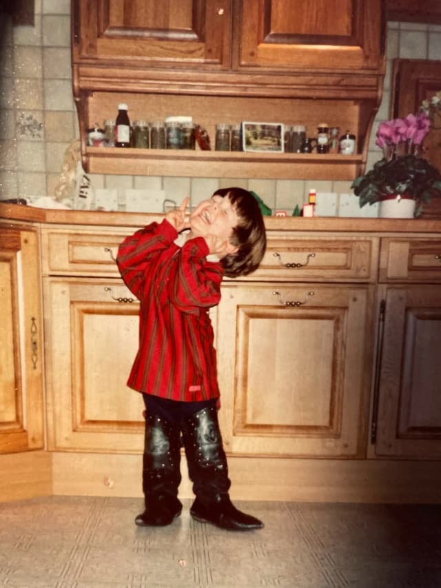 Stephen as a child playing in the kitchen